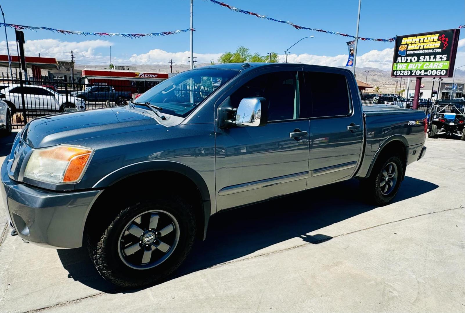 2014 grey Nissan Titan PRO-4X Crew Cab 4WD SWB (1N6AA0EC6EN) with an 5.6L V8 DOHC 32V engine, 5-Speed Automatic transmission, located at 2190 Hwy 95, Bullhead City, AZ, 86442, (928) 704-0060, 0.000000, 0.000000 - 2014 Nissan Titan crew cab 4x4. 2 owner. excellent condition. automatic, power windows, locks, tires in great shape. non smoker always garaged. elderly owned. has foldable cover for bed and carpeted bed mat. tow package. ice cold ac. just recently had complete service and all fluids changed. free an - Photo#2