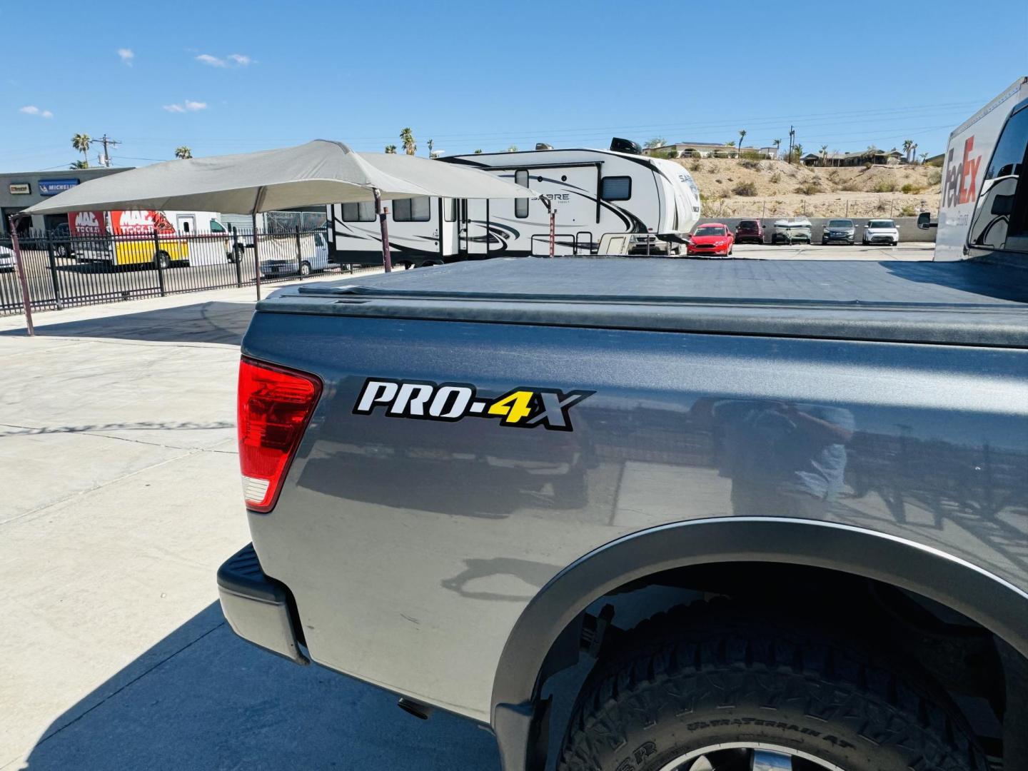 2014 grey Nissan Titan PRO-4X Crew Cab 4WD SWB (1N6AA0EC6EN) with an 5.6L V8 DOHC 32V engine, 5-Speed Automatic transmission, located at 2190 Hwy 95, Bullhead City, AZ, 86442, (928) 704-0060, 0.000000, 0.000000 - 2014 Nissan Titan crew cab 4x4. 2 owner. excellent condition. automatic, power windows, locks, tires in great shape. non smoker always garaged. elderly owned. has foldable cover for bed and carpeted bed mat. tow package. ice cold ac. just recently had complete service and all fluids changed. free an - Photo#3