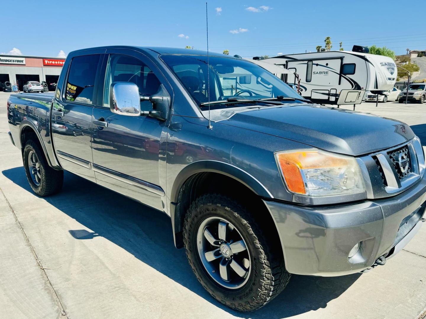 2014 grey Nissan Titan PRO-4X Crew Cab 4WD SWB (1N6AA0EC6EN) with an 5.6L V8 DOHC 32V engine, 5-Speed Automatic transmission, located at 2190 Hwy 95, Bullhead City, AZ, 86442, (928) 704-0060, 0.000000, 0.000000 - 2014 Nissan Titan crew cab 4x4. 2 owner. excellent condition. automatic, power windows, locks, tires in great shape. non smoker always garaged. elderly owned. has foldable cover for bed and carpeted bed mat. tow package. ice cold ac. just recently had complete service and all fluids changed. free an - Photo#0